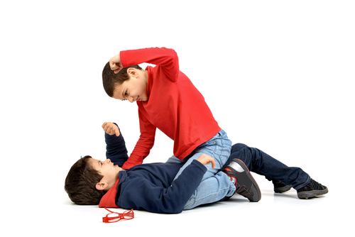 Two boys fighting isolated in white